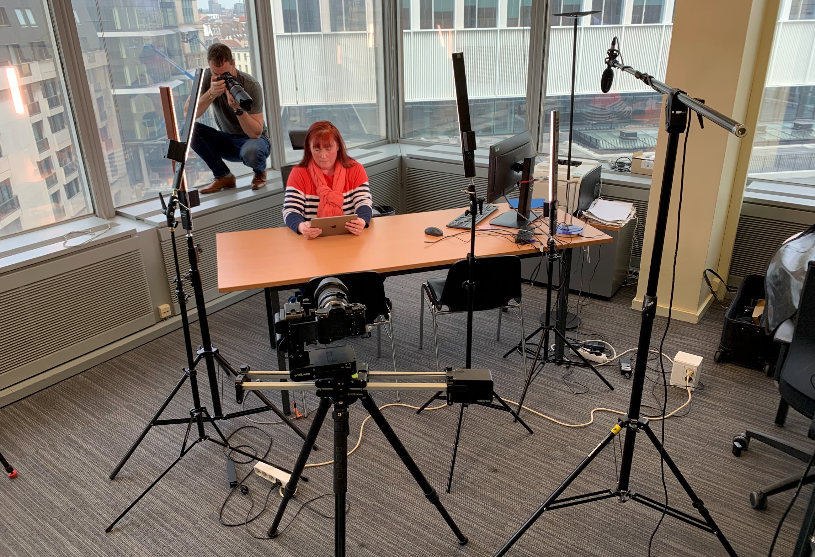 Professional video production setup with slider and LED lighting in Brussels office